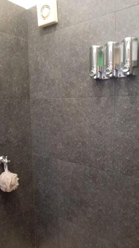 a bathroom with a shower with a tiled wall at Hacienda Gallardos 104-4 in San Carlos
