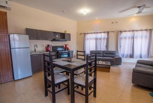 a kitchen and living room with a table and chairs at Hacienda Gallardos 104-4 in San Carlos