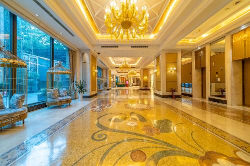 a lobby of a hotel with a chandelier at Ramada Yichang Hotel in Yichang
