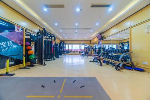 a gym with lots of equipment in a room at Ramada Yichang Hotel in Yichang