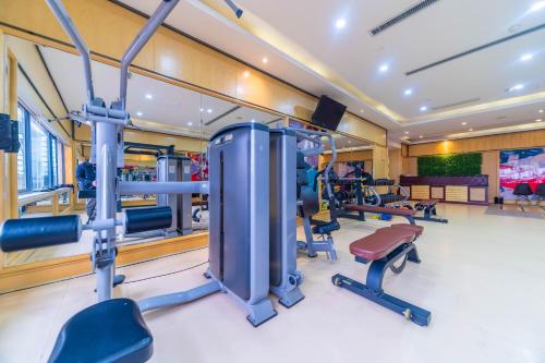 a gym with several treadmills and exercise equipment at Ramada Yichang Hotel in Yichang
