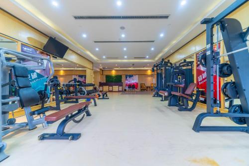 a gym with cardio equipment in a hotel at Ramada Yichang Hotel in Yichang