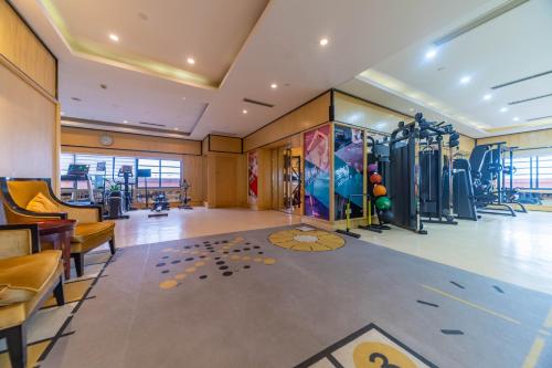 a gym with cardio equipment in a building at Ramada Yichang Hotel in Yichang