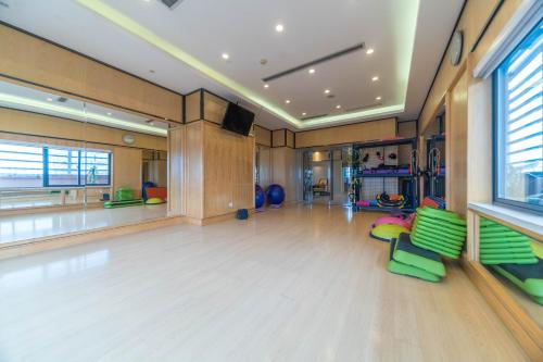a large room with green chairs and a dance floor at Ramada Yichang Hotel in Yichang