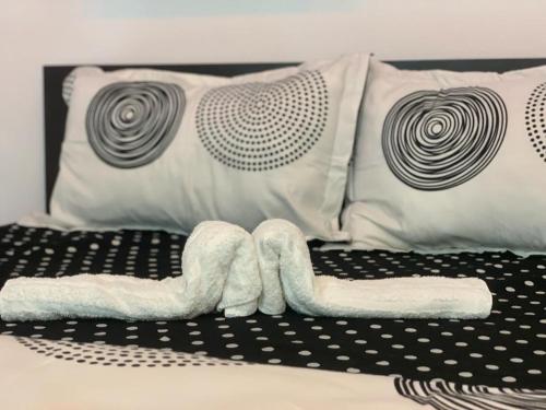 a bed with two towels and pillows on it at Apartament B Orizont in Bacău