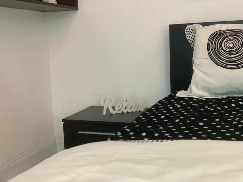 a bedroom with a bed with a black headboard and a pillow at Apartament B Orizont in Bacău