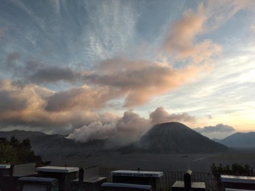 a view of a mountain under a cloudy sky at Cemara Indah Hotel in Bromo