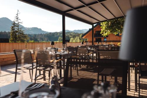 a restaurant with tables and chairs on a patio at Alpenhotel Kitzbühel am Schwarzsee - 4 Sterne Superior in Kitzbühel