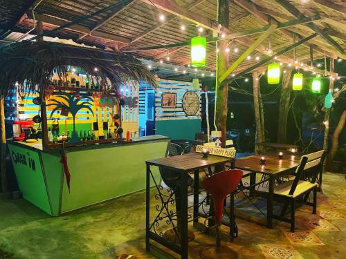 a restaurant with two tables and a bar at Freedom home in Ko Chang