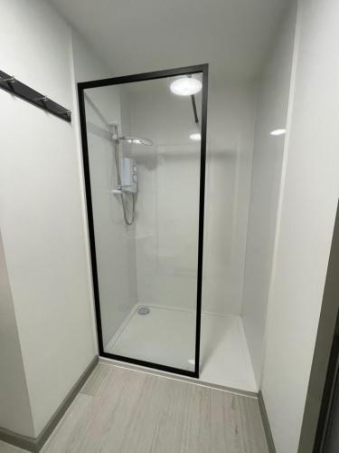 a shower with a glass door in a bathroom at Rooms in Inverness in Inverness