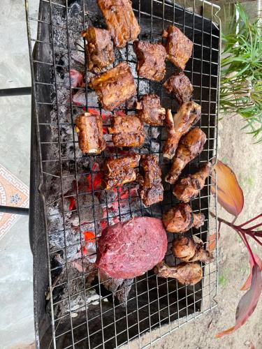 a grill with a bunch of food on it at Freedom home in Ko Chang