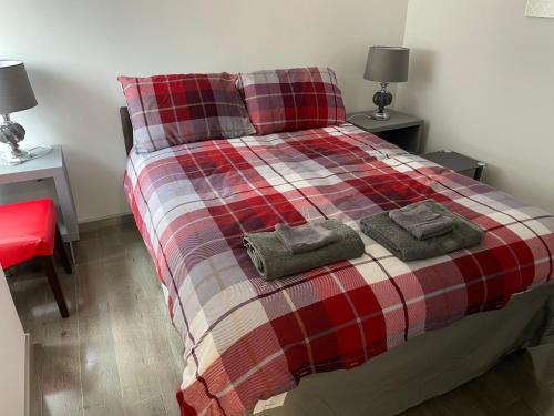 a bedroom with a bed with two towels on it at Rooms in Inverness in Inverness