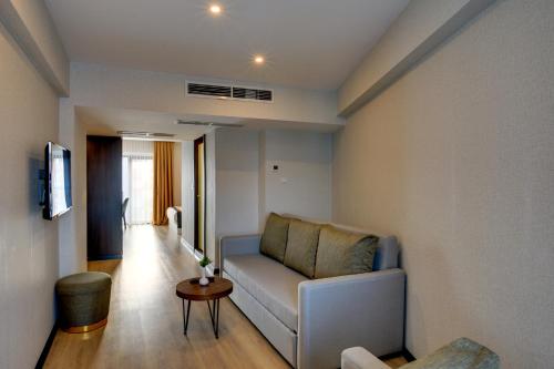 a living room with a couch and a table at Leo Suites in Bursa