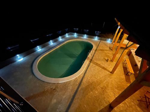 a swimming pool on the deck of a cruise ship at night at Villa Nesa - beautiful guest house at continental Croatia with Outdoor swimming pool, Sauna and 3 Bedrooms in Plaški