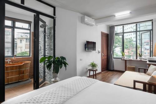 a bedroom with a large bed and a bathroom at Entire Cosy Apartments May Homestay Hanoi in Hanoi