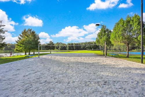 an empty volleyball court in a park with trees at Villas at Seven Dwarfs Resort - Near to Disney in Kissimmee