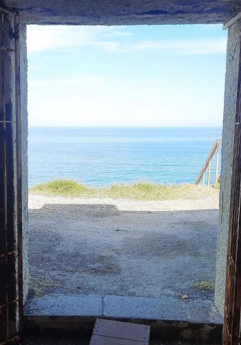 an open door to a view of the ocean at LA CASA DI MARTA in Milazzo