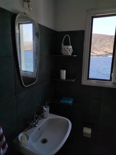 a bathroom with a sink and a window at Malli Sea House in Mamádhos