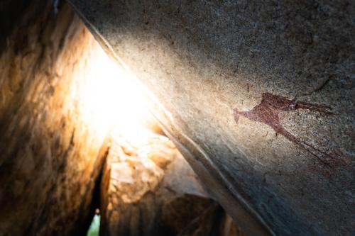 a close up of the sun shining on a wooden table at Ai Aiba - The Rock Painting Lodge in Omaruru