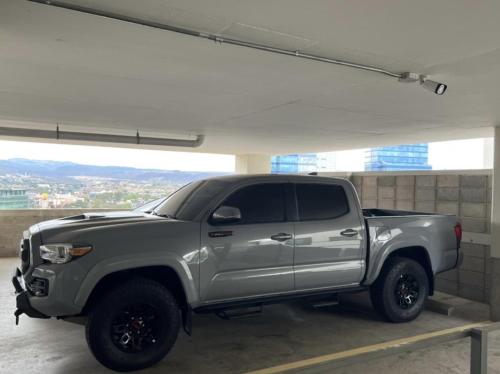 a silver truck parked in a parking garage at JF Three Bedroom Apartment in Tegucigalpa