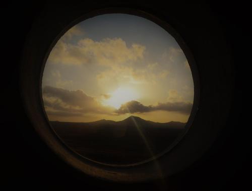 a view of the sunset from an airplane window at EL REFUGIO in Famara