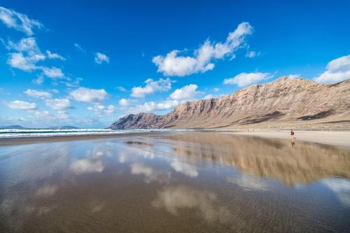 a view of a beach with a mountain in the background at EL REFUGIO in Famara