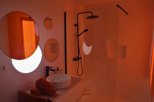 a bathroom with a sink and a shower with a mirror at EL REFUGIO in Famara