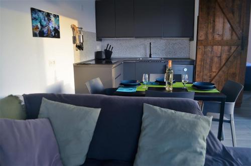 a living room with a couch and a kitchen with a table at EL REFUGIO in Famara