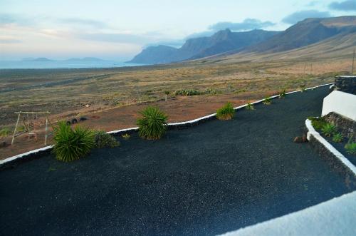 a view of a desert with mountains in the background at EL REFUGIO in Famara