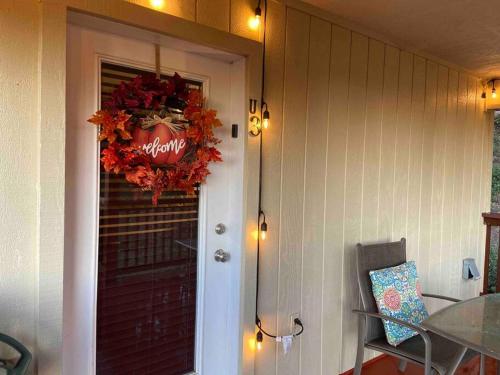 a front door of a house with a wreath on it at YoBee! Park Reservation Included! Heart of Yosemite - Homey Studios and Breakfast in Yosemite West