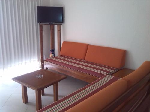 a living room with a couch and a table at Hotel y Suites Corita in Bucerías