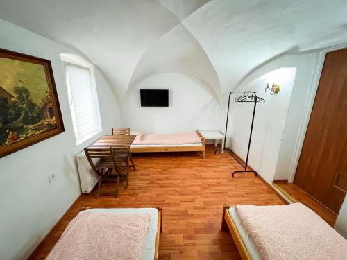 a room with two beds and a table and chairs at Noclegi WOKU in Świebodzice