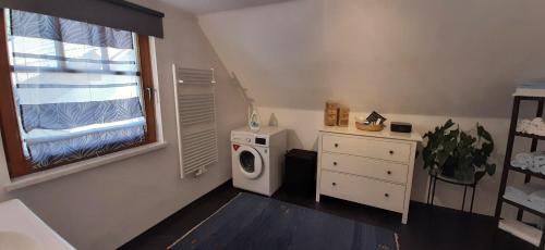 a laundry room with a washing machine and a window at Ferienhaus Familie Zimmermann in Keutschach am See