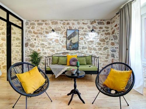 a living room with two chairs and a couch at History House Moja Ti 1830 in Old Town Senj in Senj