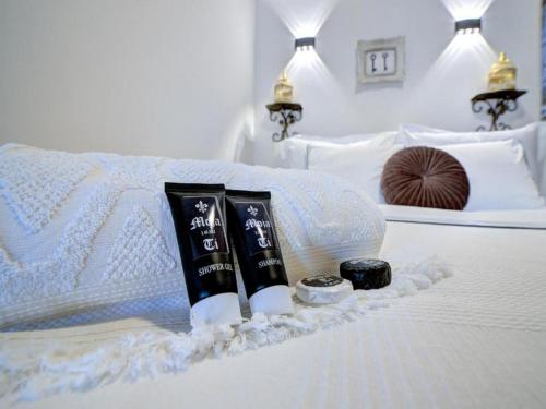 a white bed with two towels and a candle on it at History House Moja Ti 1830 in Old Town Senj in Senj