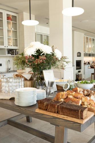 a table with bread and plates of food on it at RUNO Hotel Porvoo in Porvoo