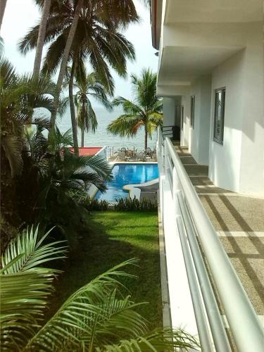 a view of a pool from the balcony of a house at Hotel y Suites Corita in Bucerías