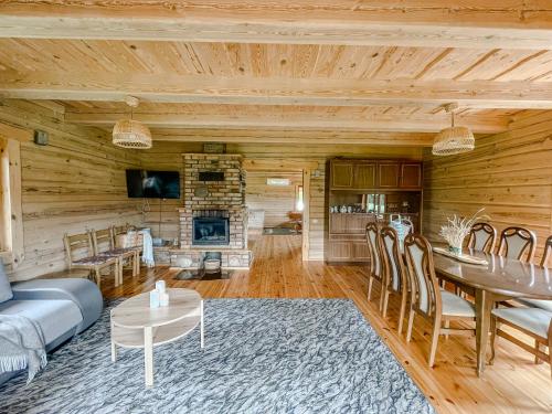 a living room with a couch and a table at Vila Juodenėnai in Žaugėdai