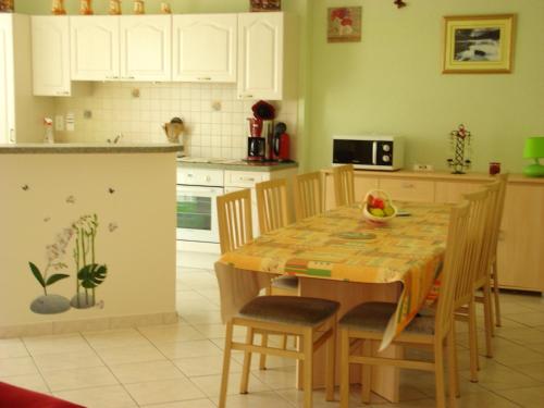 a kitchen with a wooden table and chairs in a room at Maison de 4 chambres avec terrasse amenagee a Valuejols 