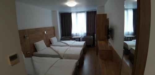 a room with a couch and a bed in a room at хотел ВИЗИЯ in Haskovo