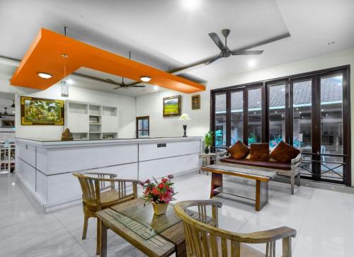 a living room with a couch and a table at Dewi Sinta Hotel and Restaurant in Tanah Lot