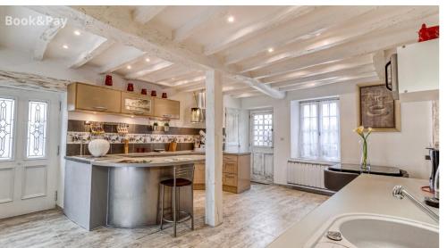 a kitchen with a large island in a room at Harmonia maison de caractère proche PROVINS in Gouaix