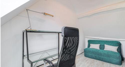 a room with a green chair and a lamp at Harmonia maison de caractère proche PROVINS in Gouaix