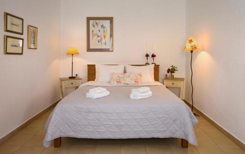 a bedroom with a bed with two towels on it at 4Elies apartments in Vourvourou