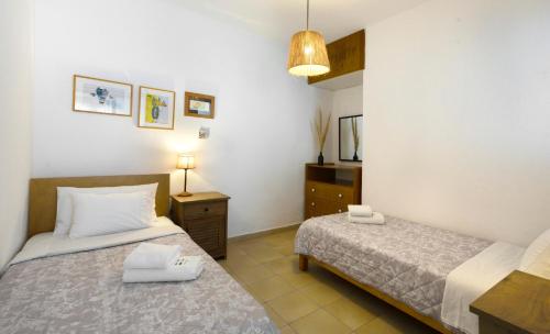 a bedroom with two beds and a mirror at 4Elies apartments in Vourvourou