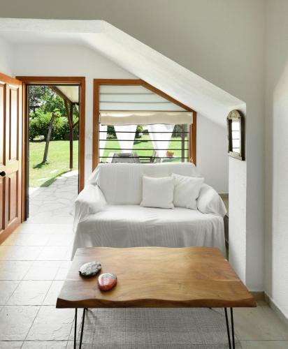 a bedroom with a bed and a wooden table at 4Elies apartments in Vourvourou