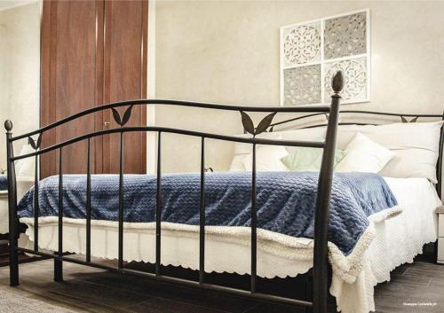 a bedroom with a bed with a blue and white blanket at Casa Nonna Fortunata in Canicattini Bagni