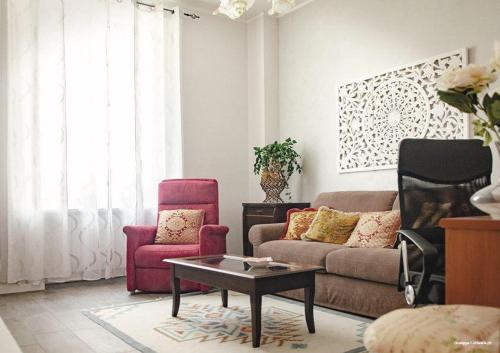 a living room with a couch and two chairs at Casa Nonna Fortunata in Canicattini Bagni