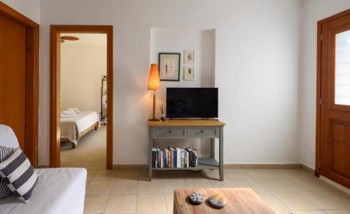 a living room with a television on a table at 4Elies apartments in Vourvourou