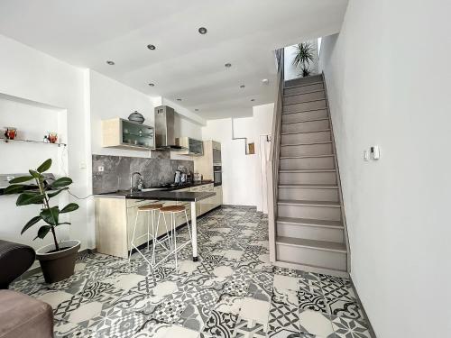 a staircase leading to a kitchen and a living room at Maison de ville jacuzzi wiffi à 4km aéroport Charleroi in Charleroi